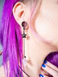 Model wearing Black Hearrings Earplug Earrings at a rave event, demonstrating their stylish appearance and secure fit