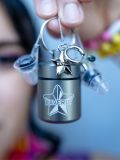 Model holding a pair of Silver Hearrings Earplug Earrings close-up, highlighting their size and design for rave and EDM fans