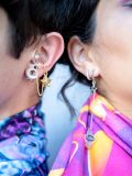 Model wearing Silver Hearrings Earplug Earrings at a rave event, demonstrating their stylish appearance and secure fit